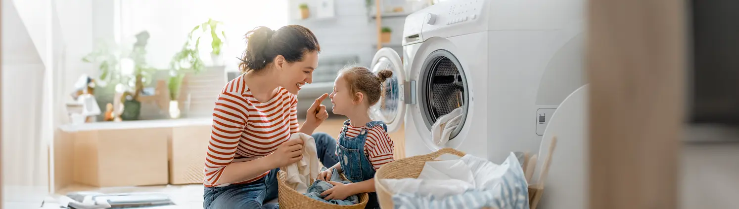 Mutter macht zusammen mit ihrer Tochter die Wäsche